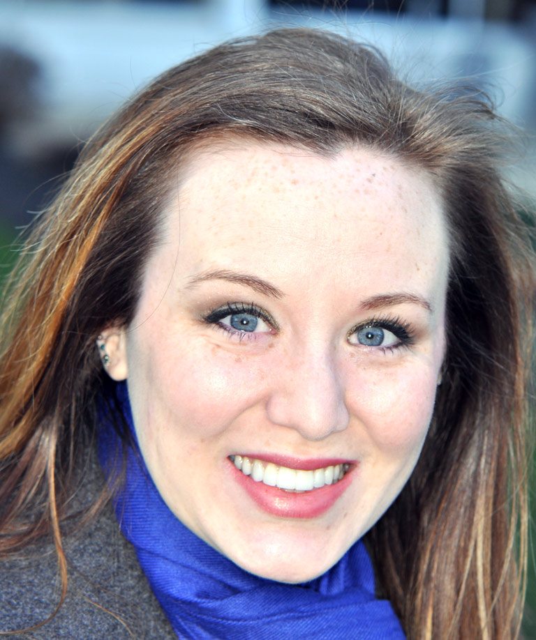 Headshot photo of female in blue scarf patient smiling showing smile makeover sults from Weiss