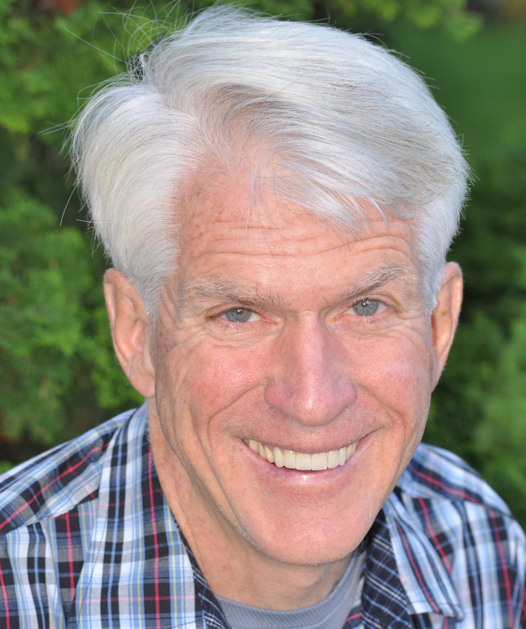 Headshot photo of older man in plaid shirt smiling showing smile makeover results from Weiss