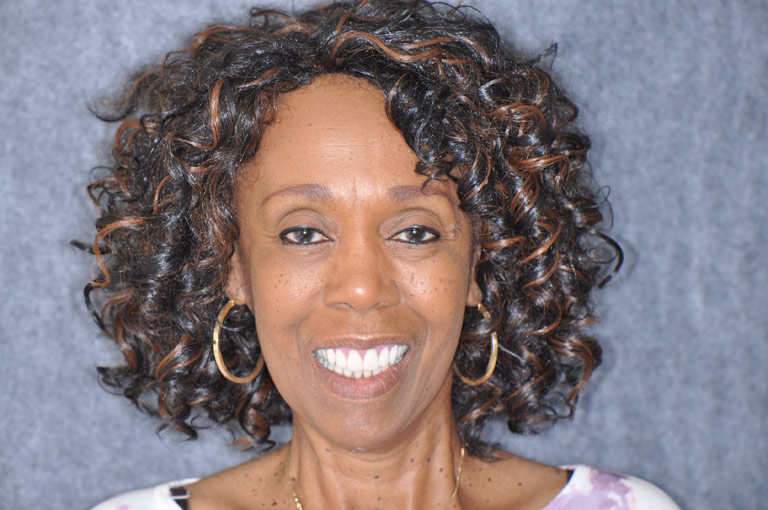 Headshot photo of african-american woman smiling after smile makeover