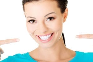 A woman pointing at her smile