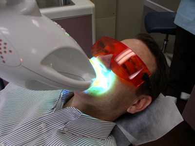 Patient under a zoom whitening light